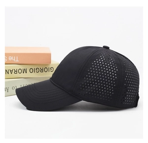 Detail of breathable laser-cut mesh and stitching on a quick-dry black baseball cap