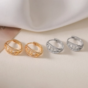 Hollow design hoop earrings in gold and silver plating with cubic zirconia crystals