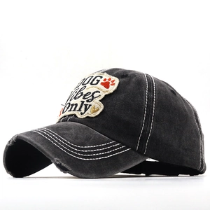 Close-up of distressed cotton baseball cap with DOG Vibes Only embroidery patch
