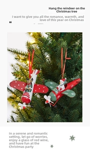 Detail view of iron airplane Christmas ornaments with moose and snowman pilots on tree