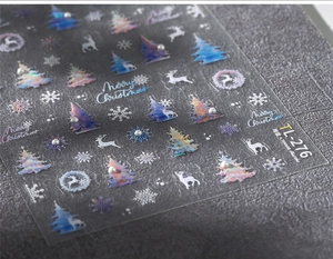 Macro detail of TL-276 Christmas nail stickers with iridescent reindeer and pearl accents