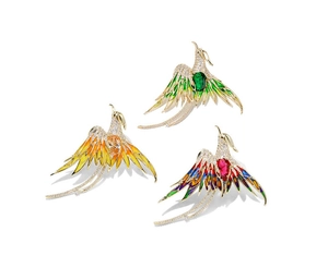 Detail of three colorful phoenix brooches with vibrant enamel and sparkling gemstones