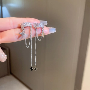 Detail of silver long chain earrings featuring sparkling zircon stars and fringe design