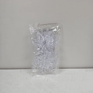 Close-up of clear acrylic snowflake ornaments in transparent self-sealing plastic packaging