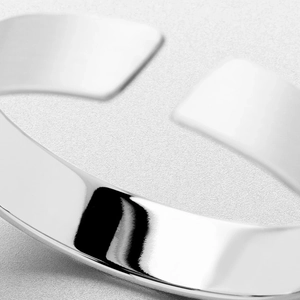 Polished minimalist titanium steel ring with smooth reflective metallic surface finish