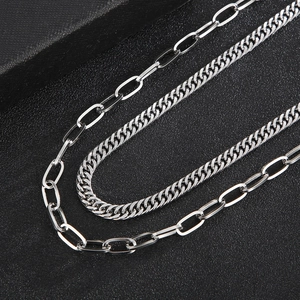 Macro detail of silver stainless steel paperclip and cuban link double layered chain