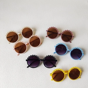 Kids round daisy sunglasses in six colors including pink blue and yellow for UV protection