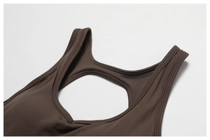 Macro detail of dark coffee yoga bodysuit featuring open back and flatlock stitching