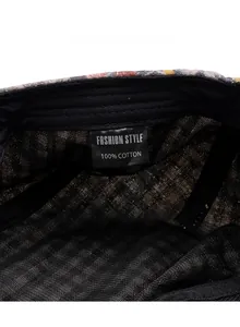 Detail showing internal care label and 100% cotton fabric texture of the plaid beret hat
