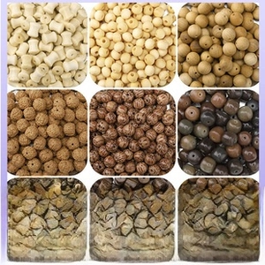 Macro display of assorted natural sandalwood and wenge wooden beads for DIY jewelry making