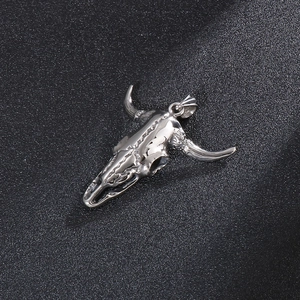 Macro view of a silver bull skull pendant showing metallic textures and gothic details