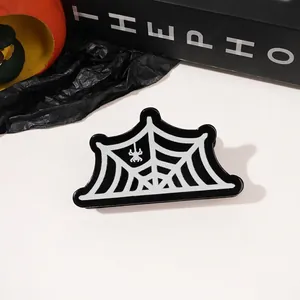 Detail of glitter spider web hair claw clip with spider design for Halloween styling