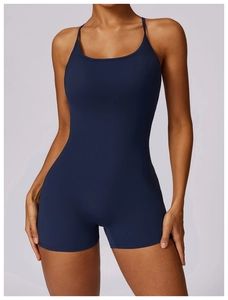 Detail of navy blue athletic bodysuit featuring thin straps and a square neckline cut
