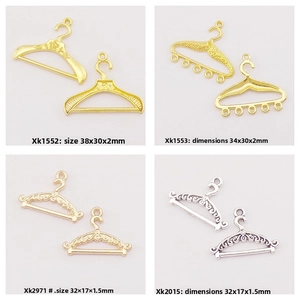 Detailed grid view of four alloy doll clothes hanger pendants in gold and silver finishes