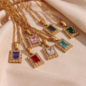 Close-up of rectangular gemstone necklaces in seven colors on beige silk fabric