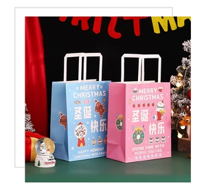 Close-up of blue and pink Christmas paper gift bags with Merry Christmas prints