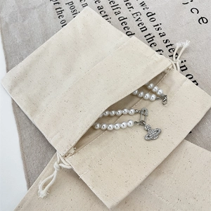 Macro view of natural canvas drawstring pouch showing durable twill texture and storage