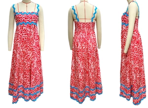 Detail view of floral maxi dress with blue scalloped trim and elastic shirred back