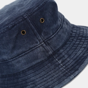 Detail of vintage navy denim bucket hat with brass eyelets and reinforced stitching
