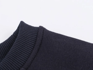 Macro view of navy blue ribbed knit texture and fine stitching on premium sweatshirt fabric