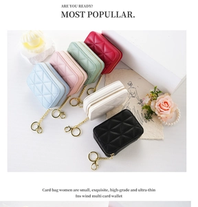 Detail shot of mini quilted lipstick bags in diverse pastel colors with gold zipper and chain
