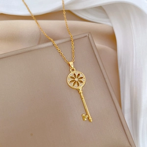 Luxurious gold sunflower key necklace with sparkling crystals on elegant silk