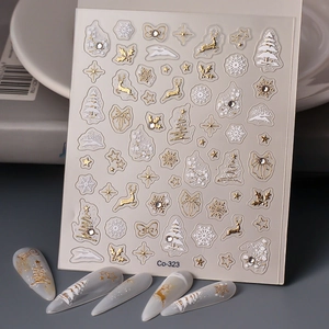 Detail of Christmas nail stickers with gold embossed snowflakes, reindeer, and trees