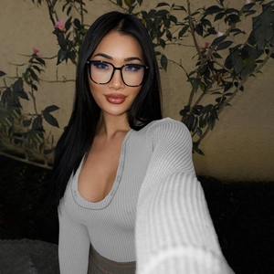 Detail of grey ribbed knit long sleeve bodysuit featuring a deep U-neck and soft texture
