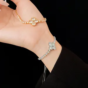 Gold and silver clover bracelets with cubic zirconia petals and delicate diamond-set chains