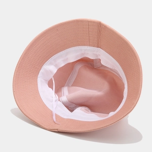 Pink cotton bucket hat with flamingo embroidery and adjustable interior white drawstrings