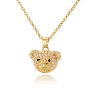 Golden bear pendant with white pearl inlay and soft mirror reflection on white background