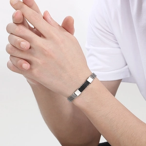 Men's minimalist silver and black braided stainless steel snake chain bracelet on model