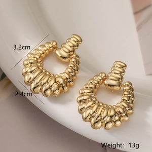 Macro shot of gold-plated wavy geometric earrings with size 3.2cm by 2.4cm and 13g weight