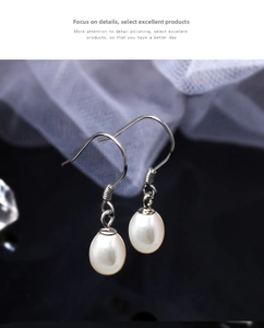 Close-up of S925 silver ear hooks featuring natural drop-shaped freshwater pearls