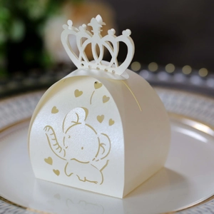 Detail of cream pearlescent favor box with laser-cut elephant and crown handle