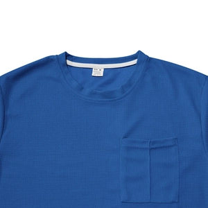 Detail of blue waffle texture fabric on men's T-shirt with pocket and collar label