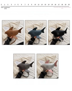 Detail view of creative shark-shaped crossbody bags in five colors with metal chain straps