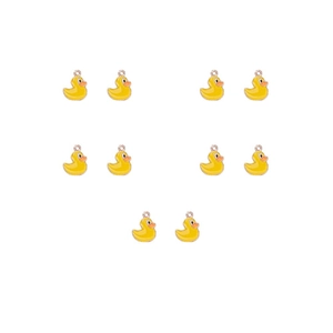 Macro view of ten yellow enamel duck alloy charms arranged on a clean white background