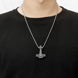 Detailed view of silver Thor's hammer pendant with Celtic knots and Valknut symbols