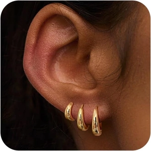 Close-up of 18K gold-plated teardrop hoop earrings worn as a stylish minimalist set