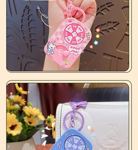 Detail of cute rotatable cartoon sports pet bag charms in pink and blue silicone