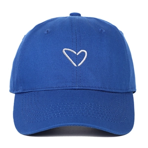 Detailed view of royal blue cotton baseball cap with white heart embroidery design