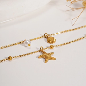 Gold stainless steel necklace with starfish shell charms and pearls for beach vacation
