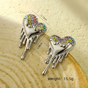 Detailed view of heart-shaped lava earrings with colorful rhinestones on ceramic