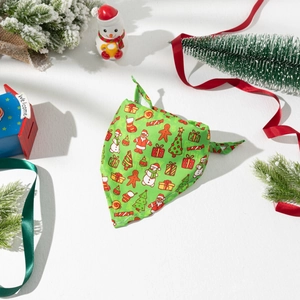 Close-up of festive green Christmas dog bandana with holiday patterns on white background
