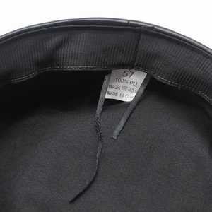 Detail view of the black PU leather hat interior with 100% PU material label and size 57