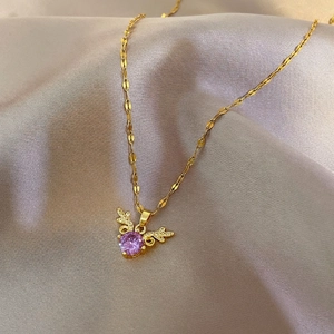 Elegant gold titanium reindeer necklace featuring a purple crystal and zircon accents