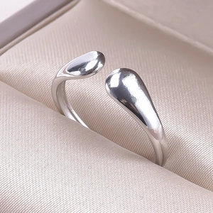 Detailed macro view of silver adjustable open ring with polished teardrop ends