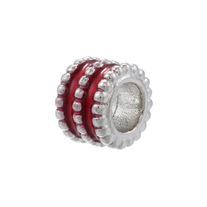 Macro detail of silver bead with red enamel stripes and cylindrical hole for jewelry DIY