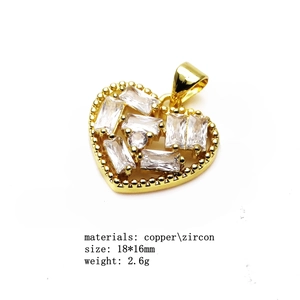 Detail of gold heart pendant with zircon inlay showing size 18x16mm and copper material